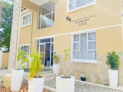 a building with plants in front of it at Henry George Hotel in Pretoria