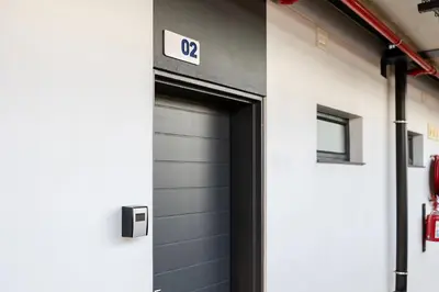 a garage door with a sign on the side of a building at Chawal Stays Green Valley 1 in Nelspruit