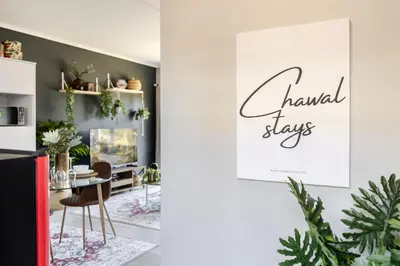 a dining room with a table and a sign that readsavid stays at Chawal Stays Green Valley 1 in Nelspruit