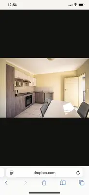 a picture of a kitchen with a table and chairs at Comfort Zone in Benoni