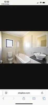 a bathroom with two sinks and a tub and a toilet at Comfort Zone in Benoni