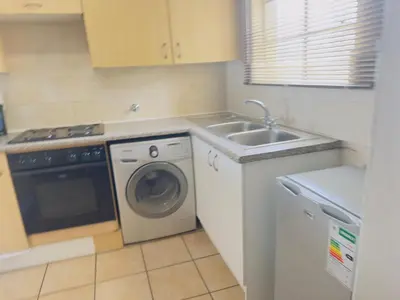 a kitchen with a washing machine and a sink at Luxury two bedrooms apartment in Witbank overnight accommodation in Witbank