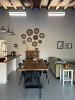 a living room with a table and a couch at Ingonyama Rest in Marloth Park