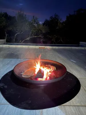a fire pit in a parking lot at night at Ingonyama Rest in Marloth Park