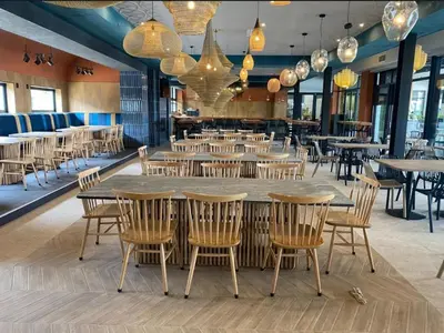 a large dining room with tables and chairs at Beach-Style Modern Apt at The Blyde in Pretoria
