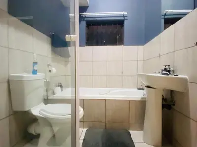 a bathroom with a toilet and a sink at A spacious 1bedroom apartment in the heart of Kempton Park in Kempton Park