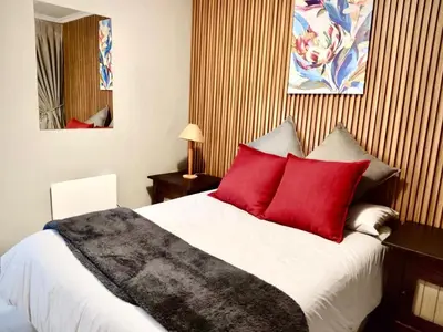 a bedroom with a large bed with red pillows at Little Swift 1 in Secunda