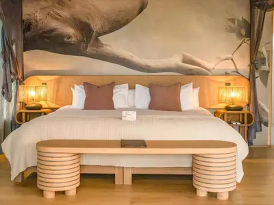 a bedroom with a large bed and a table at 18 On The Hill in Mica