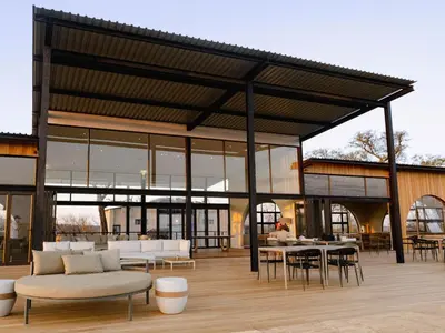 a pavilion with white couches and tables and chairs at 18 On The Hill in Mica