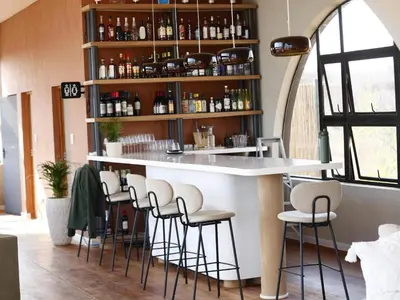 a bar in a restaurant with stools around it at 18 On The Hill in Mica