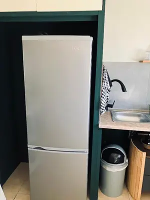 a white refrigerator in a kitchen next to a sink at Willow Cottage in Evander