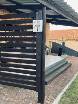 a sign on a pole next to a patio at Willow Cottage in Evander