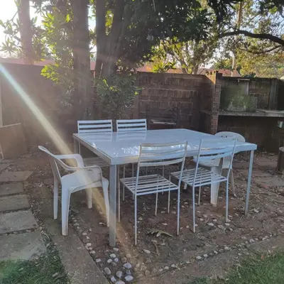 a blue table and chairs in a yard at Kruin suite in Pretoria