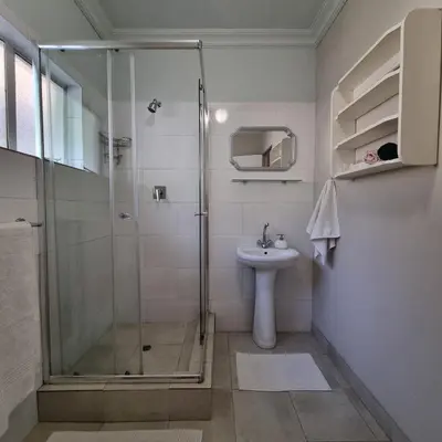 a bathroom with a shower and a sink at Kruin suite in Pretoria