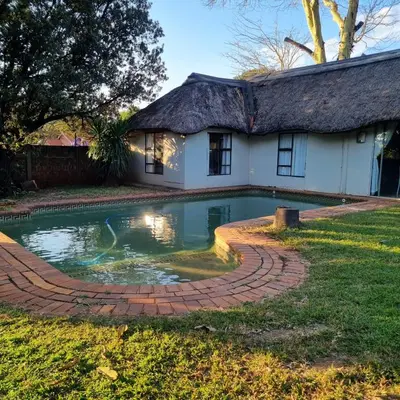 a house with a swimming pool in the yard at Kruin suite in Pretoria