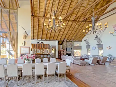 a dining room with a large table and chairs at Buffalo Game Lodge in Warmbaths