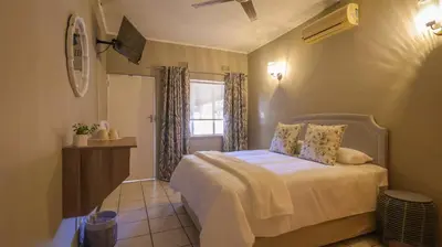 a bedroom with a bed and a window at Stay at Percy2 in Nelspruit