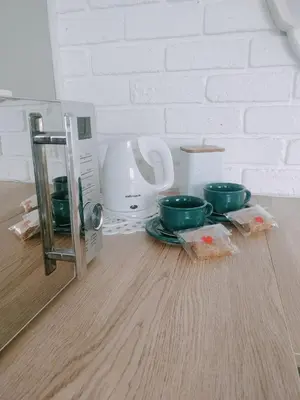 a kitchen counter with two green bowls on the floor at Stay at Percy2 in Nelspruit