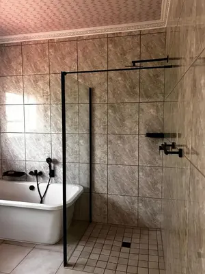 a bathroom with a shower and a tub and a sink at Pebetzel Luxury Home XX2 in Kempton Park