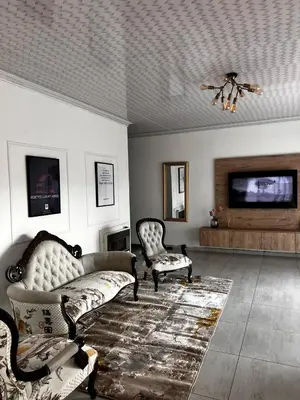 a living room with two chairs and a couch at Pebetzel Luxury Home XX2 in Kempton Park