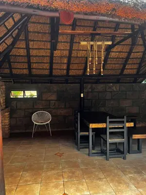a room with a table and chairs in a roof at Pebetzel Luxury Home XX2 in Kempton Park