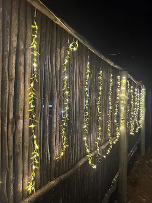 a wooden fence with christmas lights on it at Rose's Lodge
