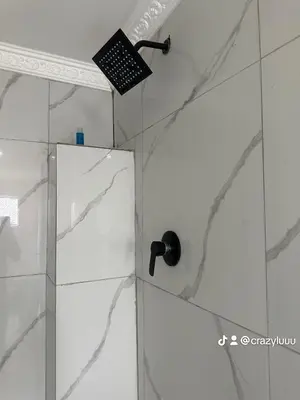 a shower with a glass door in a bathroom at Rose's Lodge