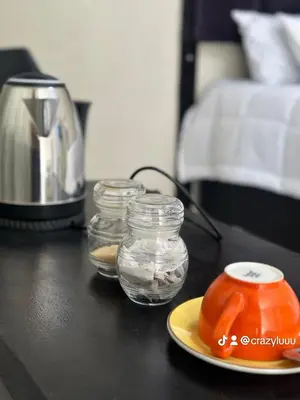 a table with three jars of water and a blender at Rose's Lodge