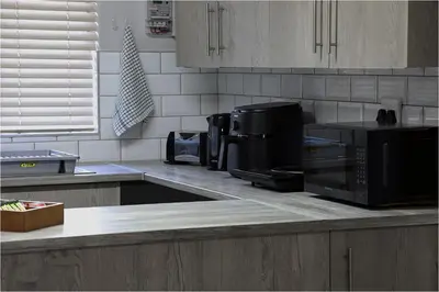 a kitchen counter with a microwave and a stove at Casa Beato in Pretoria