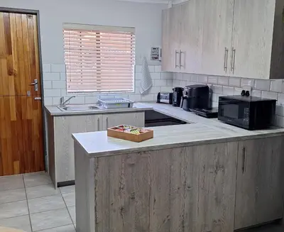 a kitchen with a counter top with a microwave at Casa Beato in Pretoria