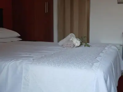 a white bed with a towel on top of it at Tushiya in Witbank
