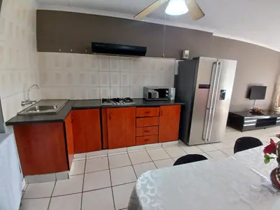 a kitchen with a sink and a refrigerator at Tushiya in Witbank