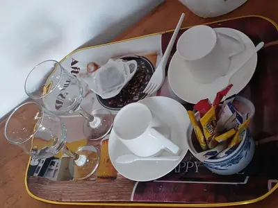 a tray with dishes and wine glasses on a table at Tushiya in Witbank