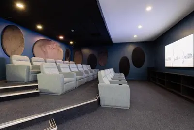a room with white chairs and a wall with planets at The Bylde Crystal Lagoon Apartment in Pretoria