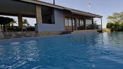 a large swimming pool in front of a house at 7 Heaven Boutique Hotel in Burgersfort