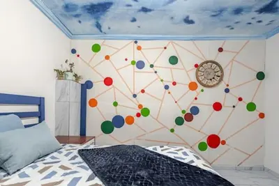 a bedroom with a wall with a clock on it at Monoshez in Benoni