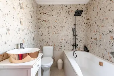 a bathroom with a sink and a tub and a toilet at Monoshez in Benoni