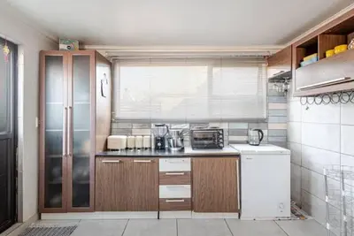 a kitchen with a refrigerator and a counter top at Monoshez in Benoni