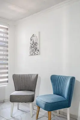 two chairs sitting next to each other in a room at Monoshez in Benoni