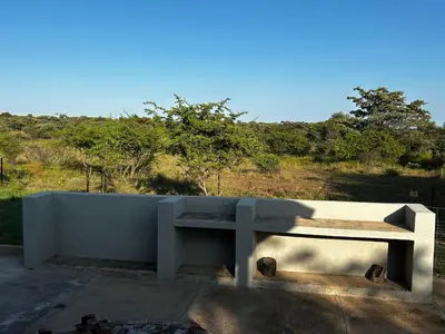 a concrete bench sitting on top of a concrete wall at Dinokeng Bush Cabin in Hammanskraal