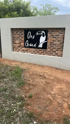 a one grand sign on a brick wall at Dinokeng Bush Cabin in Hammanskraal