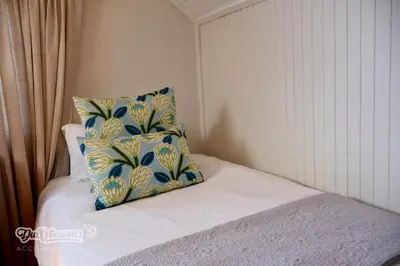 a bed with a pillow sitting on top of it at Tall Trees in Dullstroom