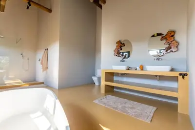 a bathroom with a sink and a mirror at Luxury & Wildlife Mlambo Lodge Mjejane in Hectorspruit