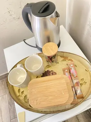 a table with a tea pot and a tray of food at Cosy Room steps from the lake- short term stay in Benoni