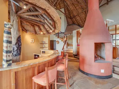 a kitchen with a large fireplace in a room at 210 Zebula, 5-bedroom villa in Warmbaths