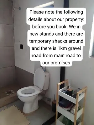 a bathroom with a toilet and a sign that reads please note the following details about at Mokoena Village guesthouse in Akasia