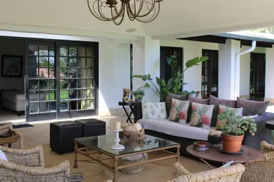 a living room with a couch and a table at South Lawn Boutique Horse Hotel in Midrand