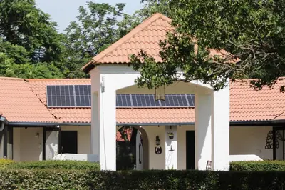 a house with solar panels on its roof at South Lawn Boutique Horse Hotel in Midrand
