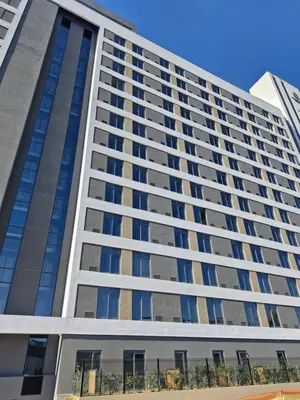 an office building with a lot of windows at Emerald Studio Menlyn Maine in Pretoria