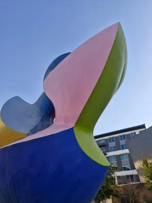 a sculpture of a flower in front of a building at Emerald Studio Menlyn Maine in Pretoria